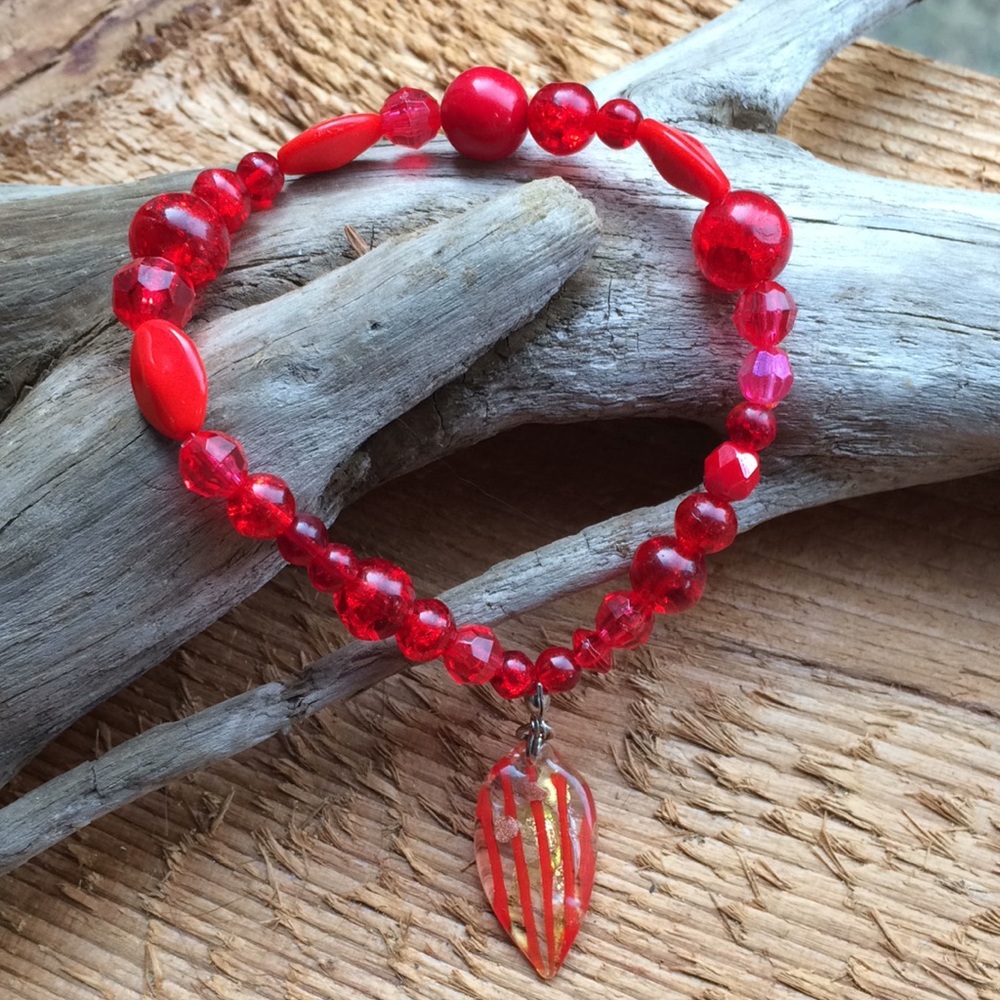 Handmade red bead bracelet with glass charm